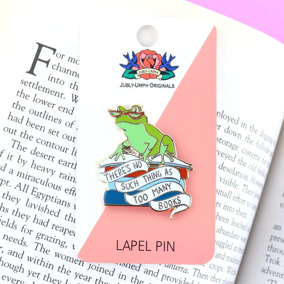 Jubly-Umph_theres_no_such_thing_as_too_many_books_lapel_pin_on_page_of_book_in_packaging