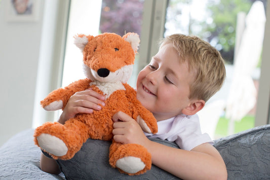 Warmies_red_fox_sitting_with_child